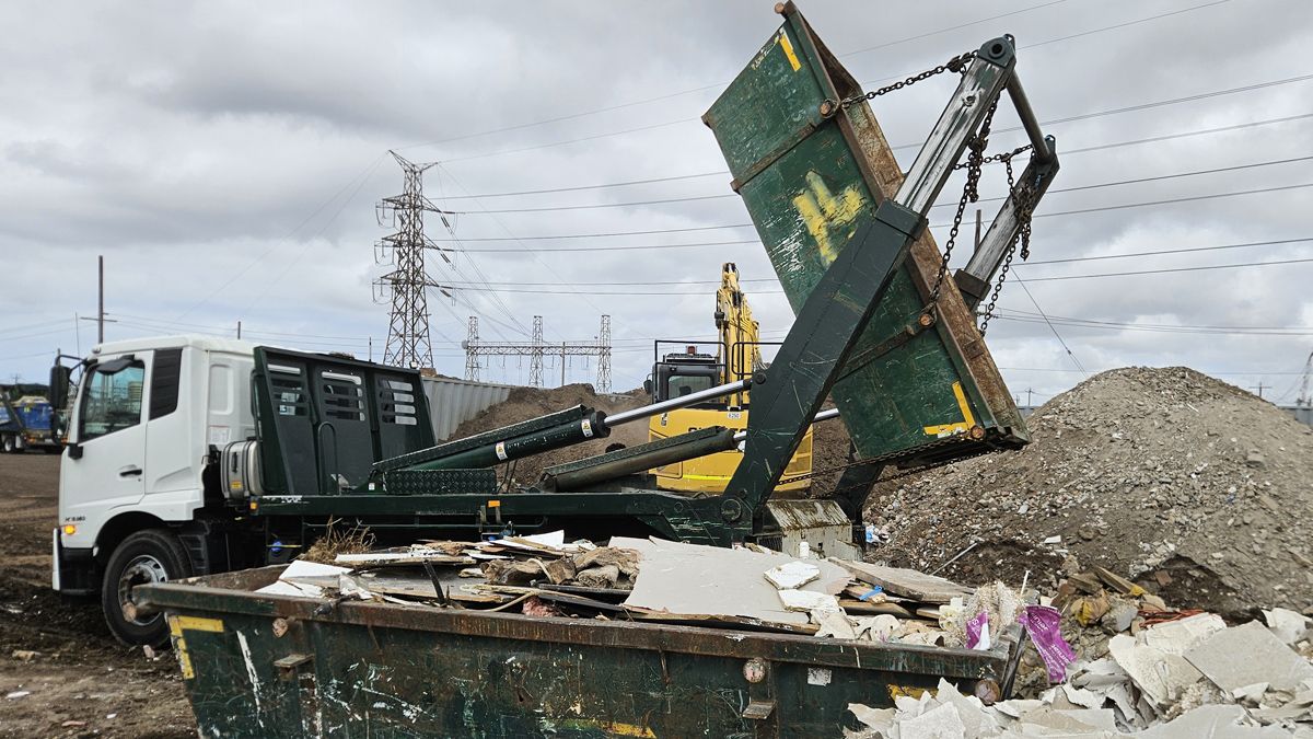 Marrel skip bin truck tipping waste at Apex Bins transfer station in Brooklyn Melbourne